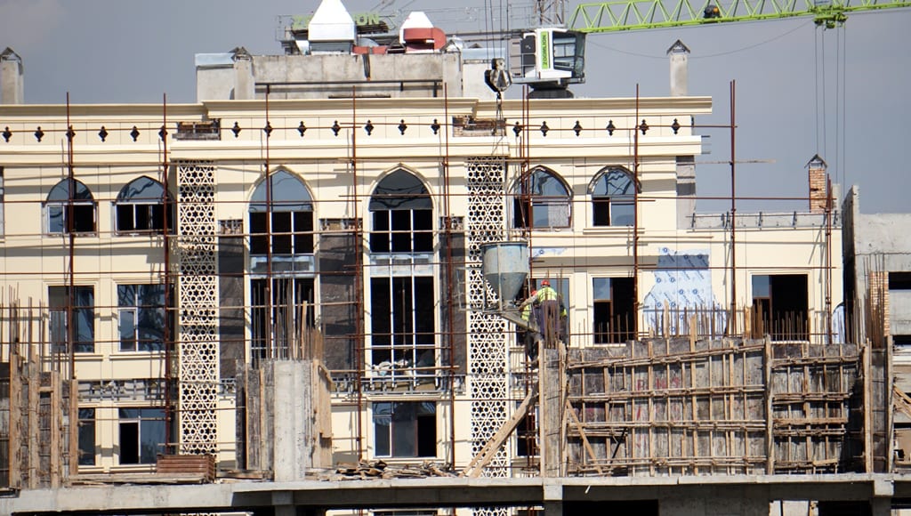Who in Tajikistan accepts new buildings and is there a warranty period for a house?